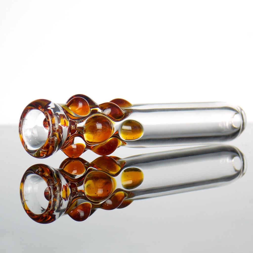 clear glass one hitter smoking pipe with amber honey
